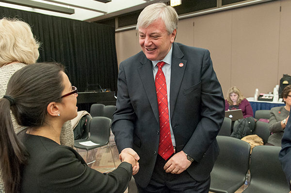 UIC Faculty member shaking hands with a student